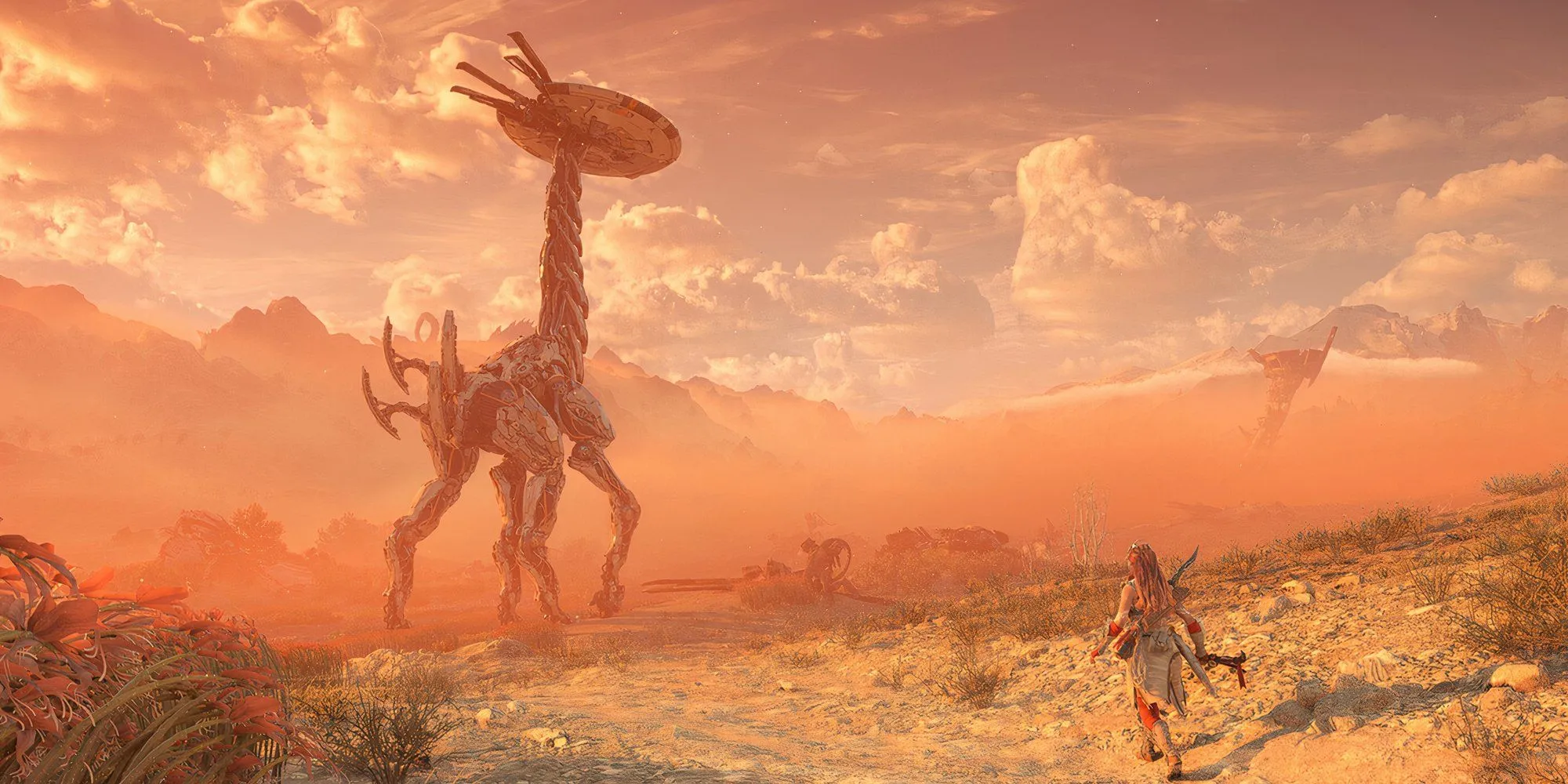 Nhân vật Aloy trong Horizon Forbidden West đối mặt với một cỗ máy khổng lồ giữa thiên nhiên hùng vĩ