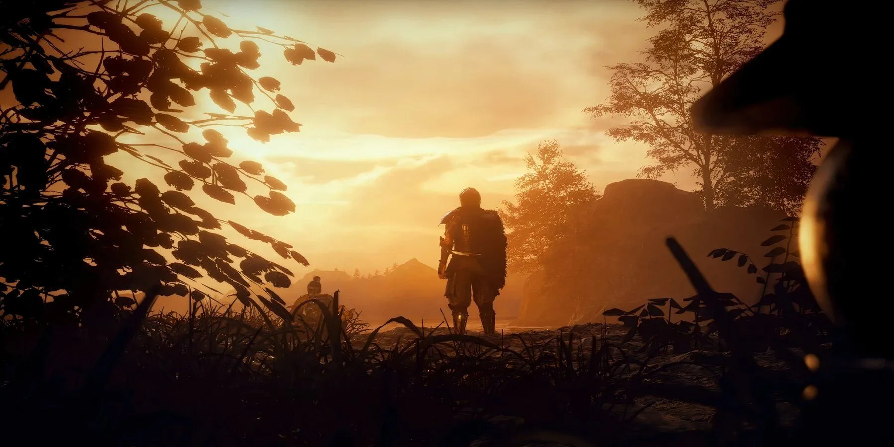 Nhân vật chính nhìn về phía mặt trời lặn trong Nioh 2, game Souls-like samurai với chiến đấu phức tạp