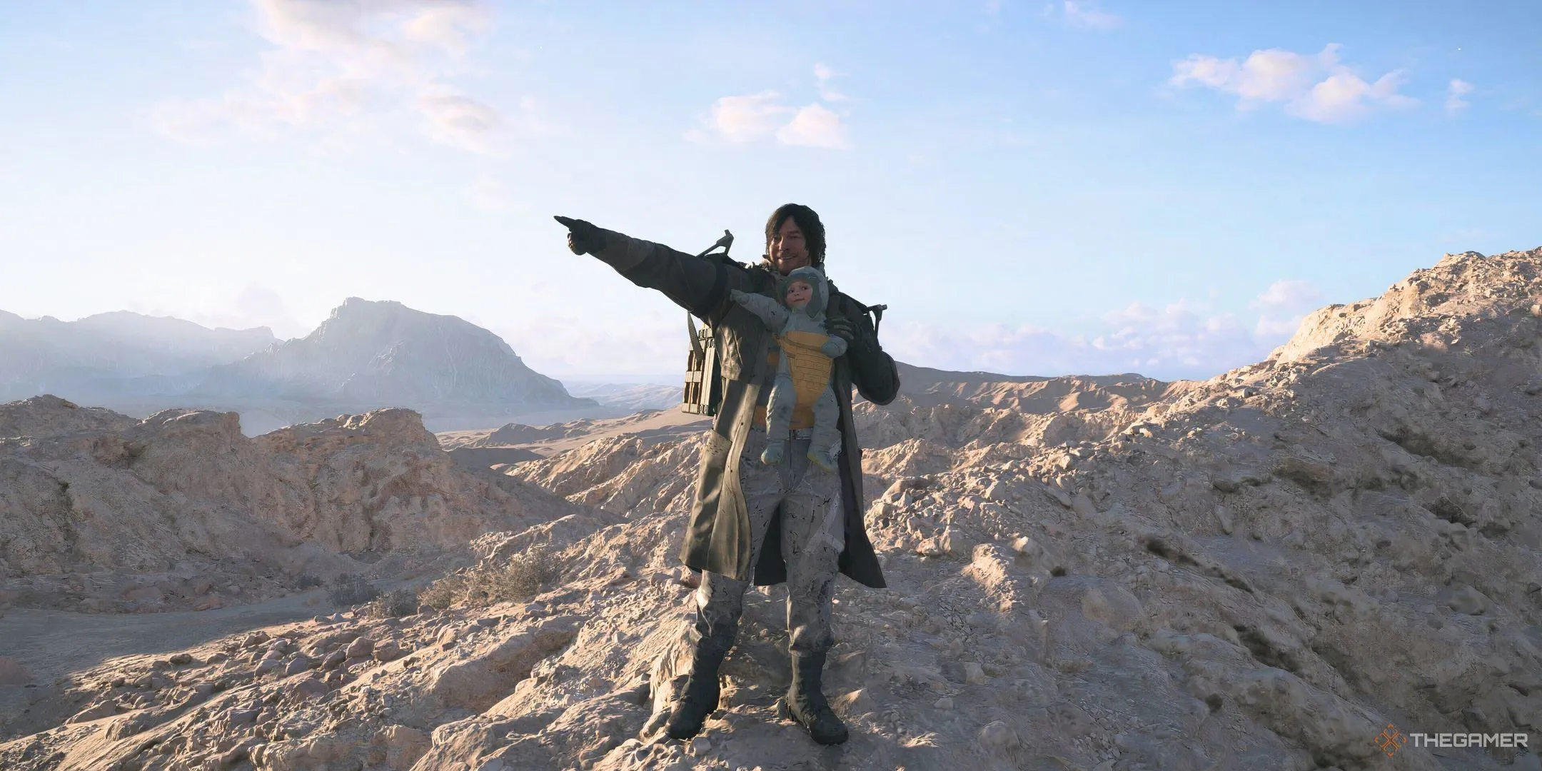 Sam Porter Bridges mặc áo khoác ôm Lou trong khung cảnh hoang vắng của Death Stranding 2: On the Beach.