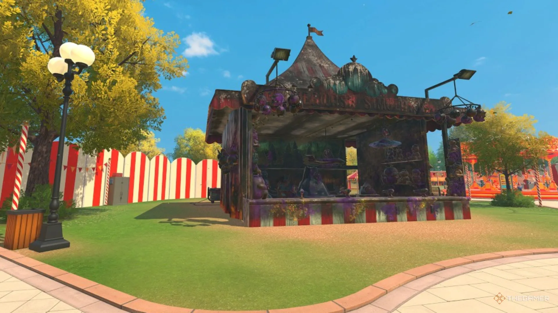 Gian bắn súng hội chợ phủ bụi nằm giữa công viên sạch, chờ được làm sạch trong PowerWash Simulator 2.